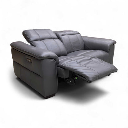 The Navy Leather Power Recliner Sofa with the footrests extended and power headrests adjusted for optimal comfort.