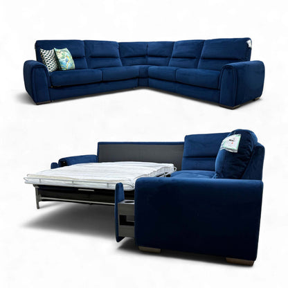 Angled view of the Navy Velvet Corner Sofa, showcasing its large footprint, deep seats, and wide, rounded armrests.
