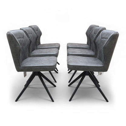 Full front view of the Aydin Swivel Dining Chair in Dark Grey Soft Faux Leather, showcasing its modern shape and on-trend stitching detail.