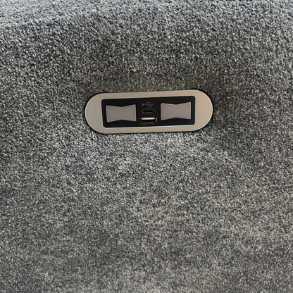 Close-up of the integrated power recliner control panel on the side of the sofa's arm.