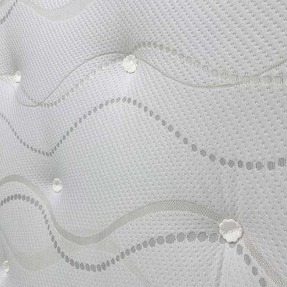 Close-up of the mattress corner, showing the material and hand-tufted design.