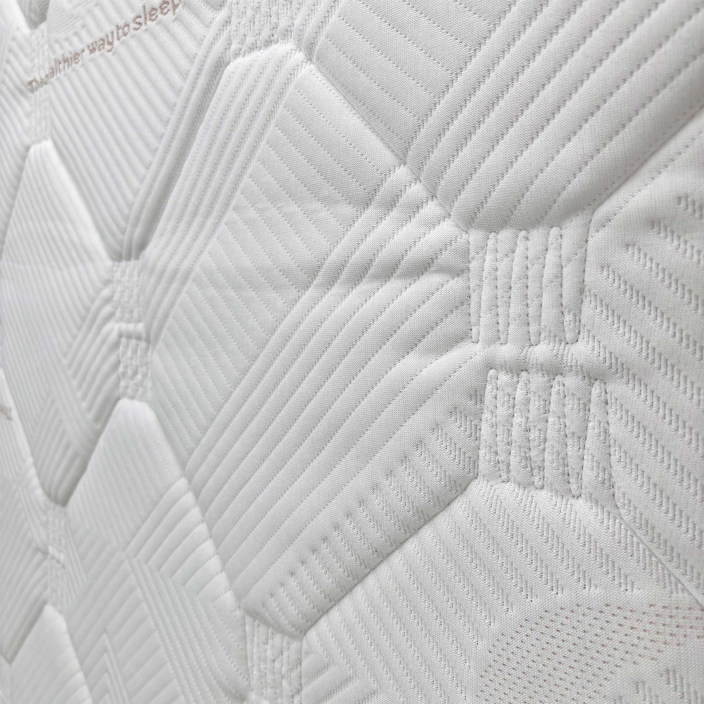 Close-up of the mattress corner, showing the material and stitching.