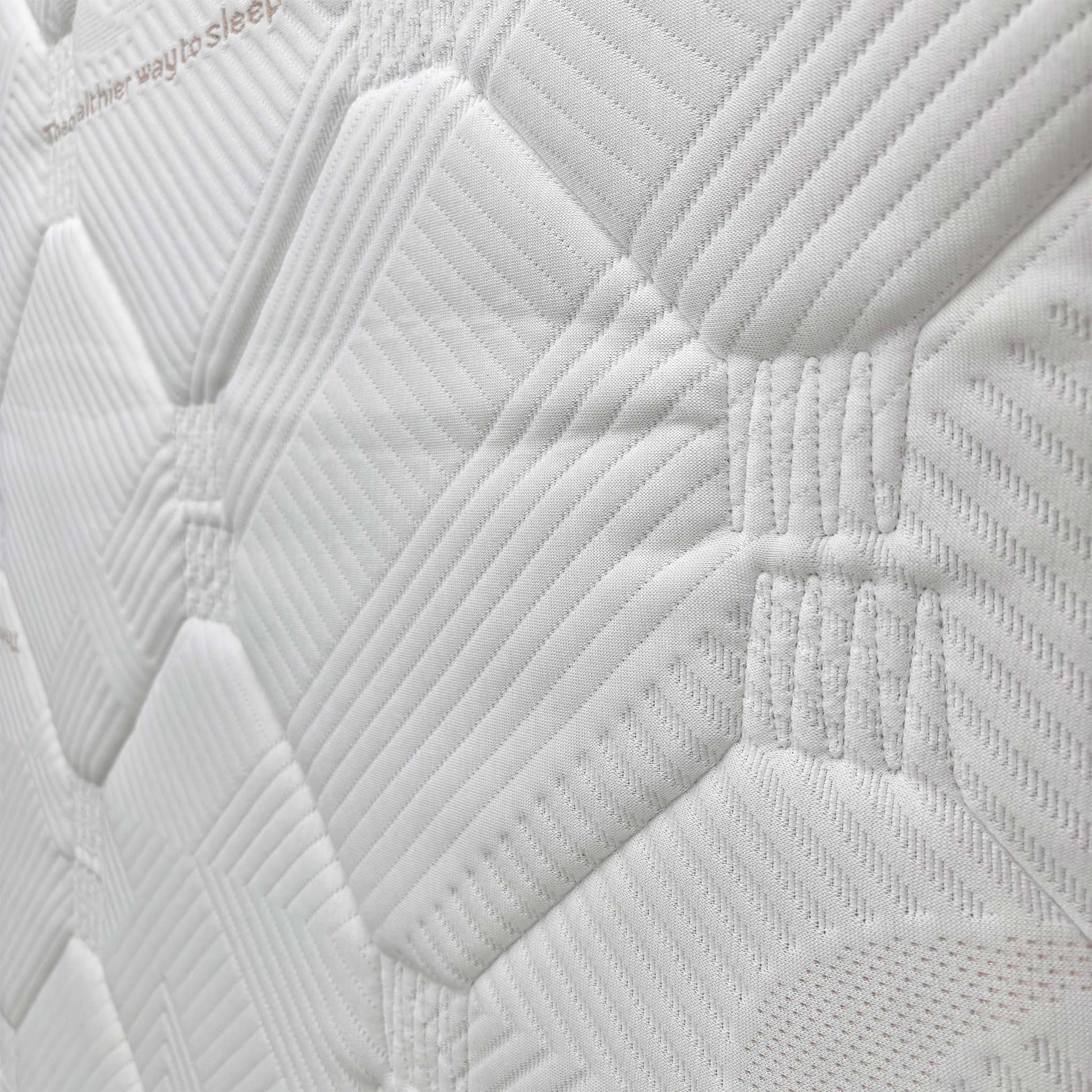 Close-up of the mattress corner, showing the material and stitching.