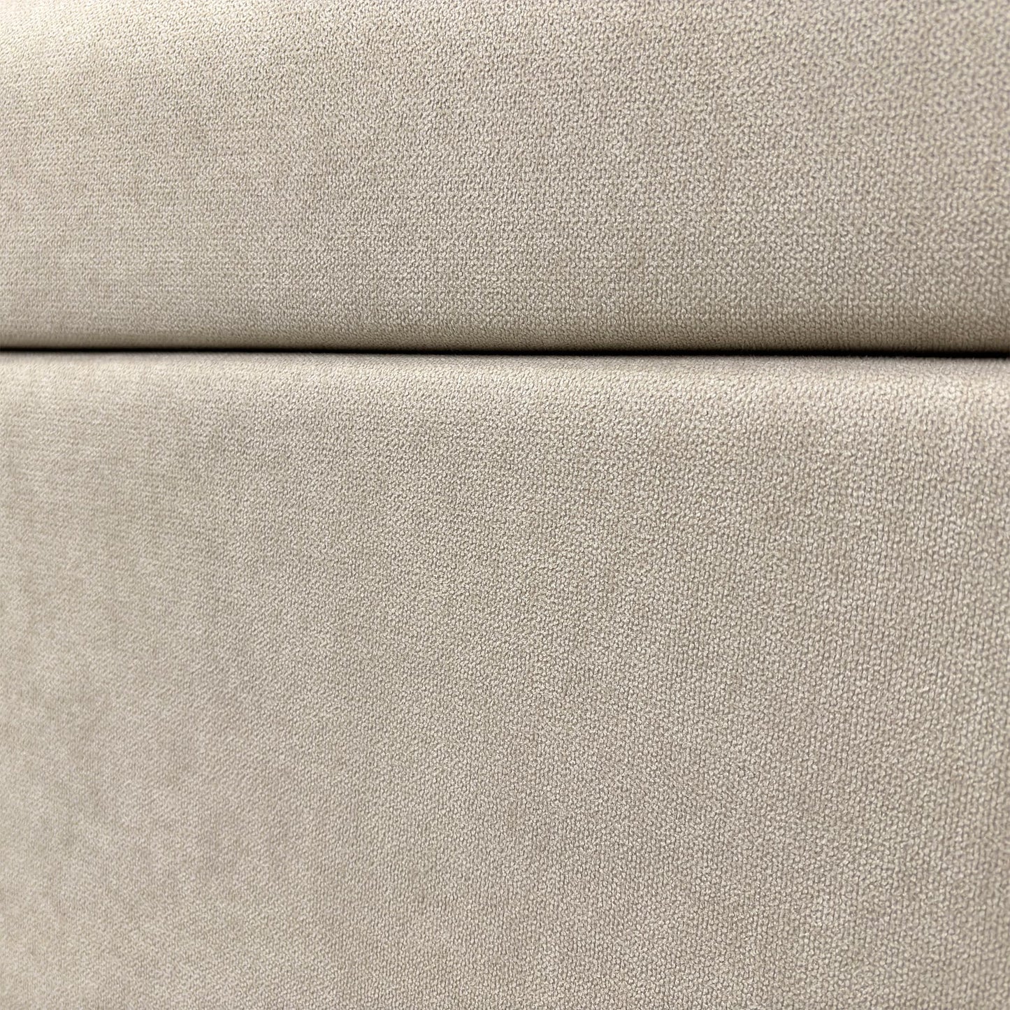 Close-up on the headboard and the upholstered fabric.