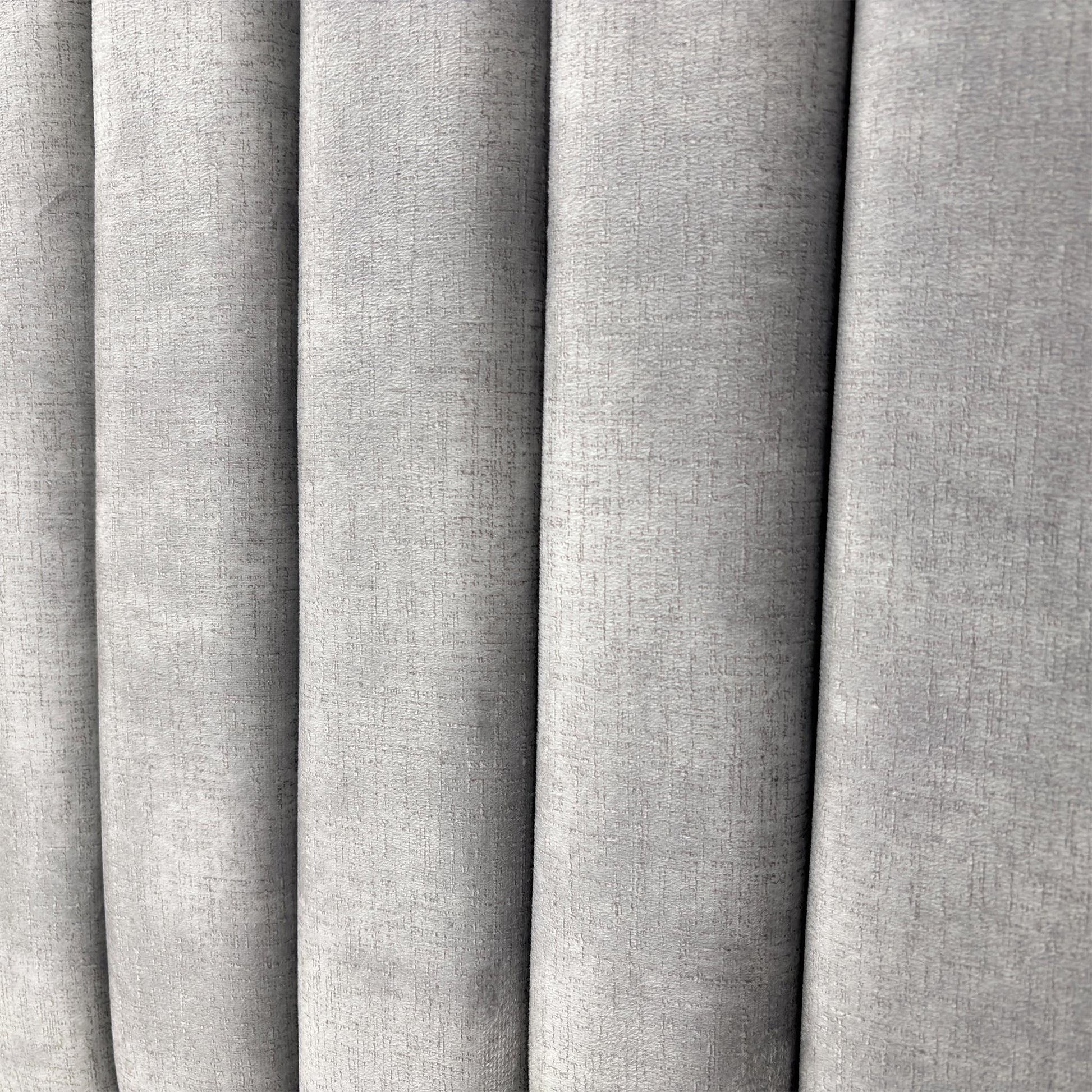 Close-up on the decorative Lace detailing and stitching pattern on the Dolphin Velvet headboard.