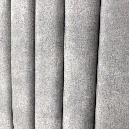 Close-up on the decorative Lace detailing and stitching pattern on the Dolphin Velvet headboard.