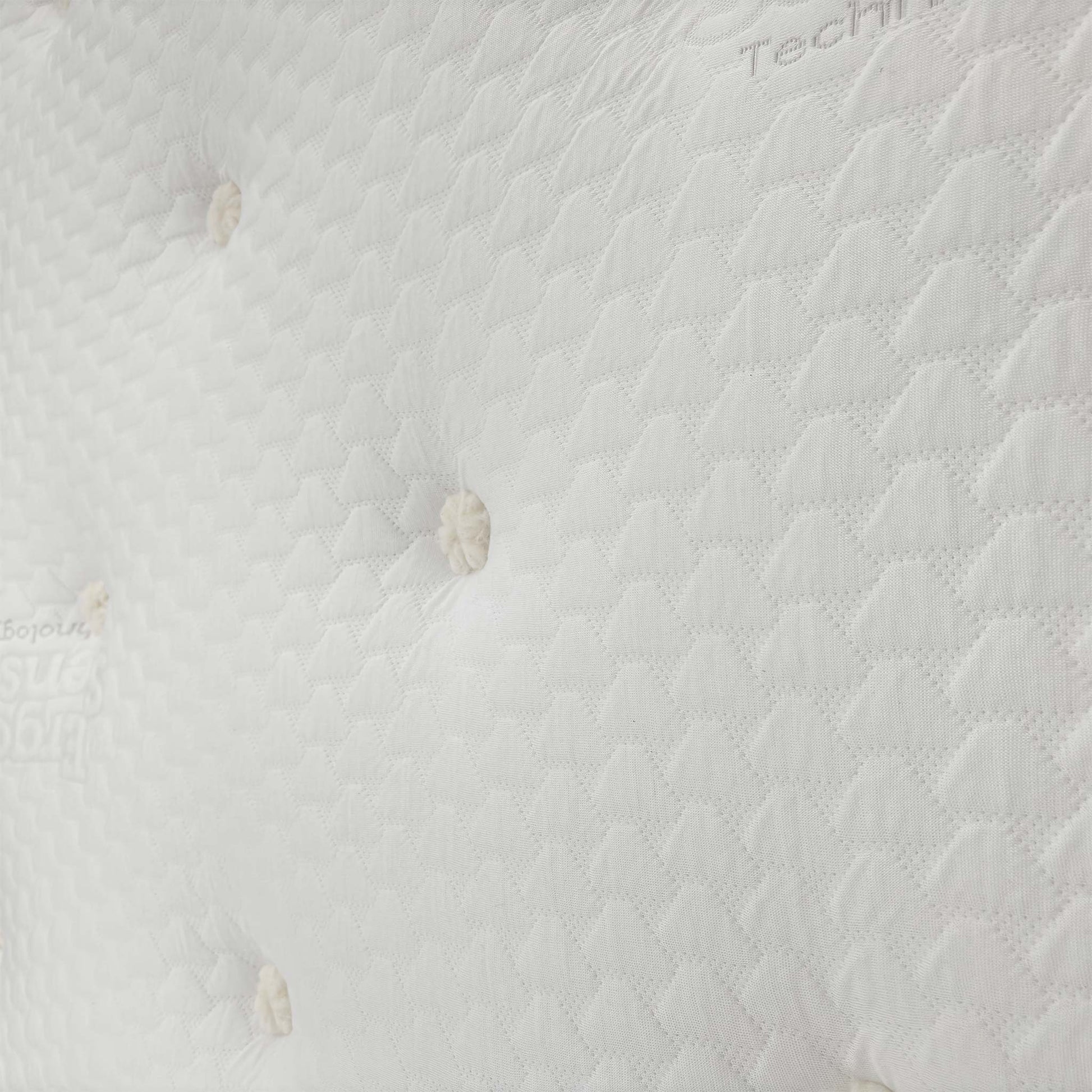 Close-up of the hand-tufted surface of the Hypoallergenic Mattress, emphasizing the texture of the breathable stretch fabric.