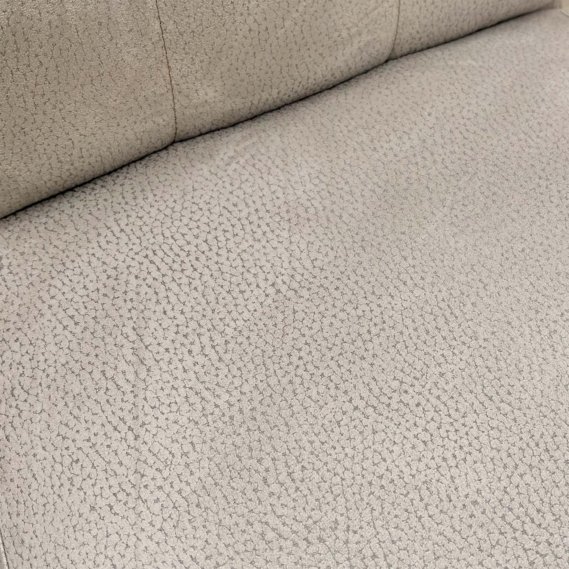 close-up of the button-back detail and texture of the silver suede upholstery on the Mia Dining Chair.