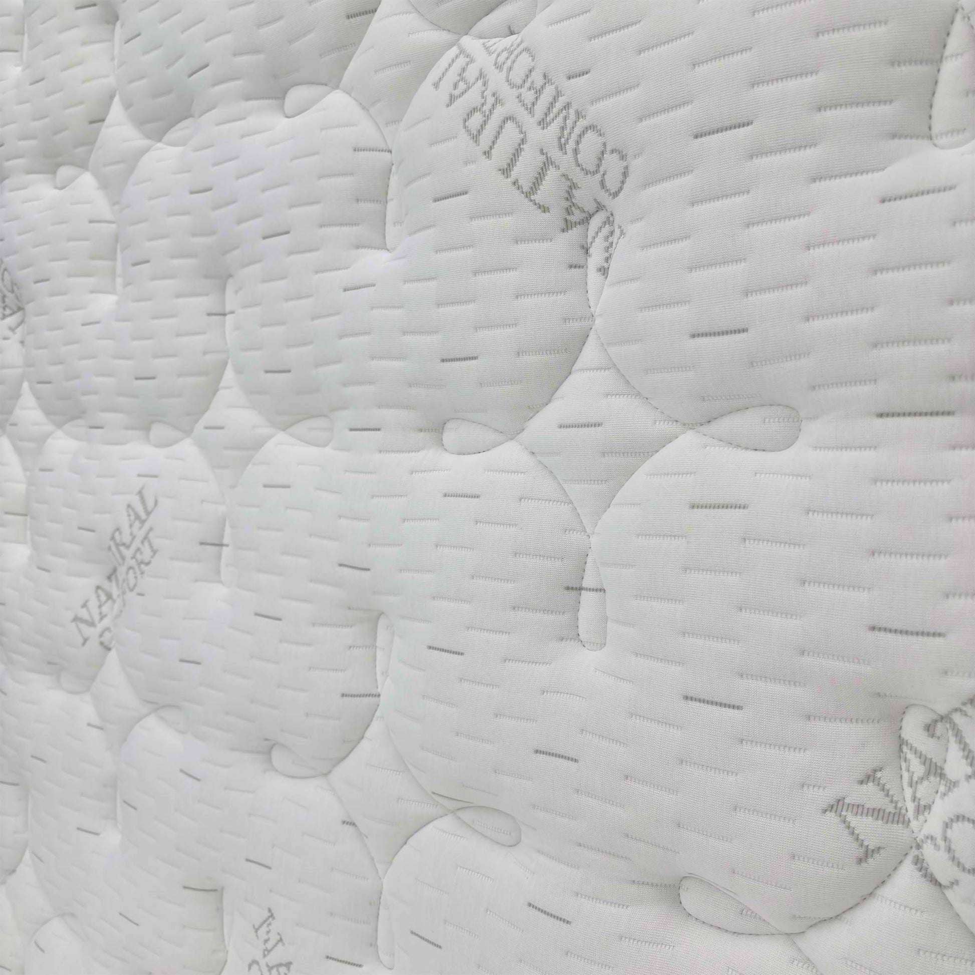 Close-up of the hand-tufted mattress surface and side border, showing the craftsmanship and thick, supportive 36 cm depth.