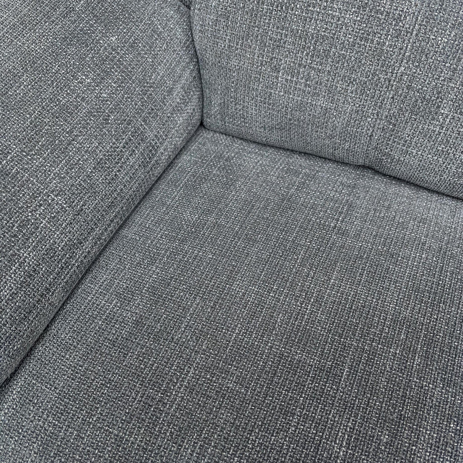 Detail shot of the Gunmetal Grey Woven Fabric and the comfortable fixed seat cushions with pocket coil spring suspension.