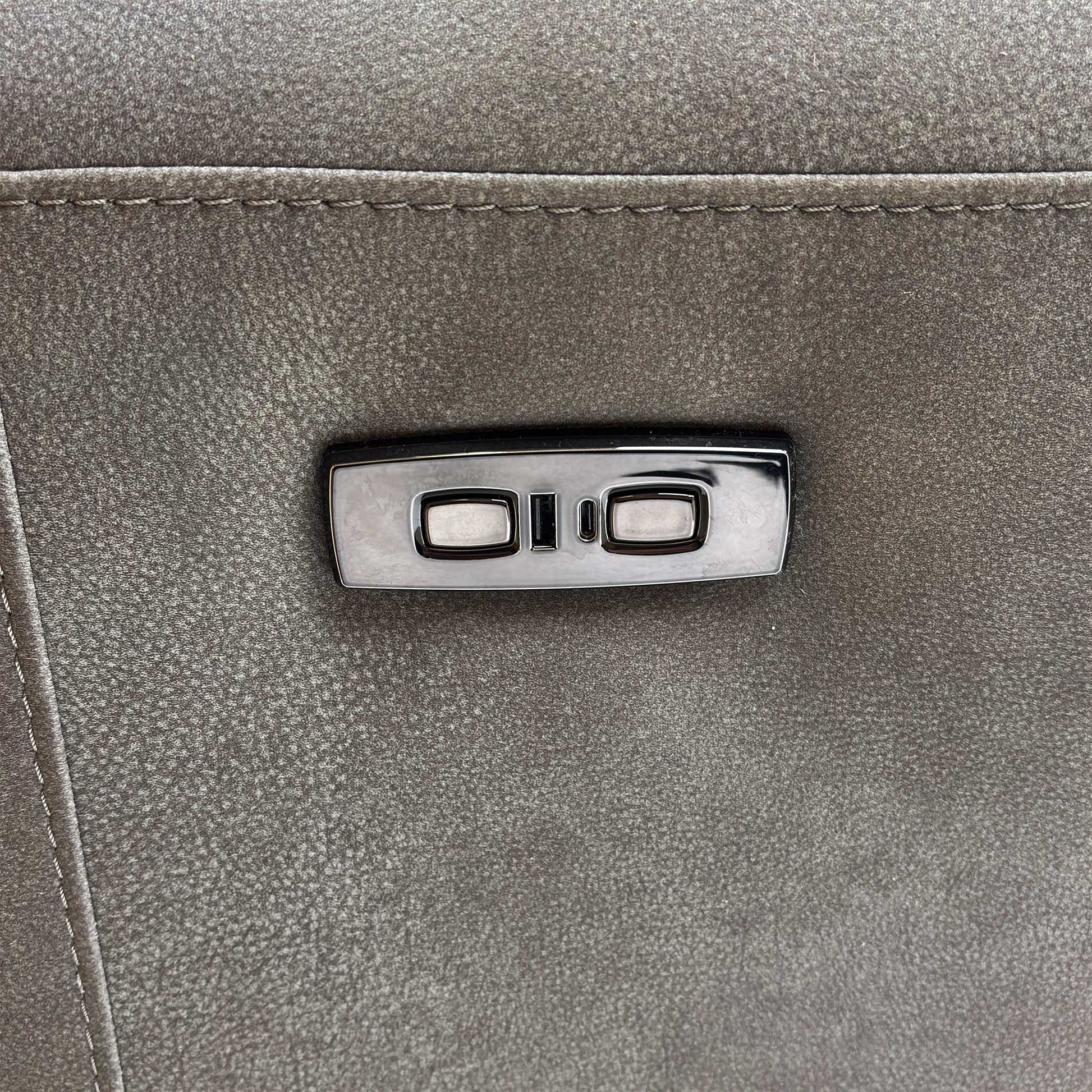 Close-up of the power controls and USB charging port on the sofa's armrest.
