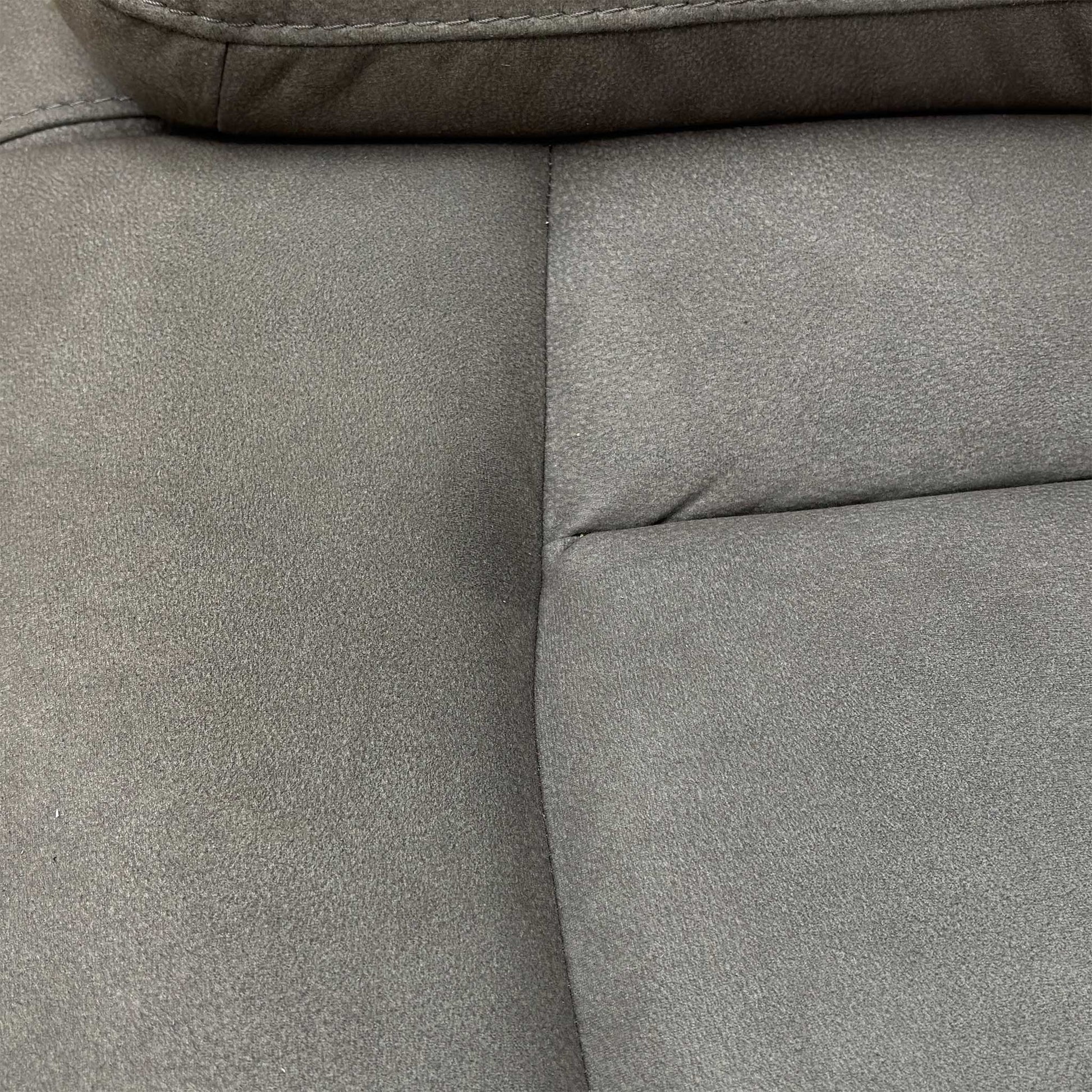 Close-up of the center media console of the Cinemax 2 Seater Power Recliner Sofa, featuring cupholders and storage in Nappa Grey fabric.