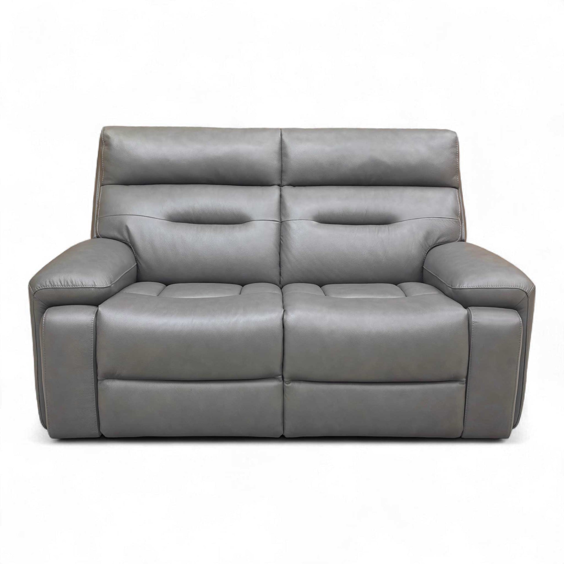 Frontal view of the Cinemax Grey Leather Sofa, highlighting its medium comfort level and fixed seat cushions.