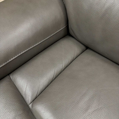 Close-up of the smooth grey LE 9308 leather upholstery and detailing on the fixed seat cushions.