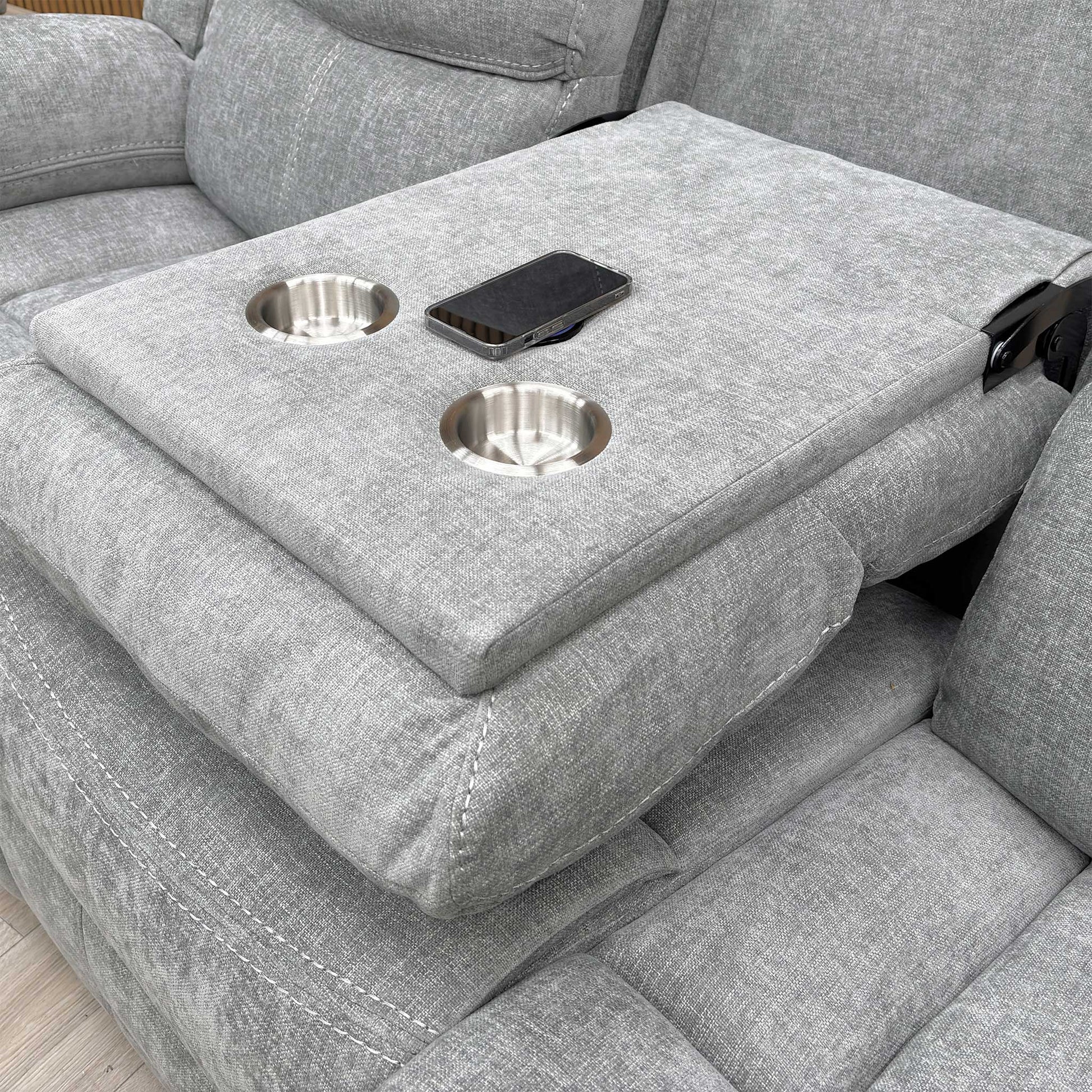 Close-up shot of the two circular cup holders within the dropped-down console of the middle seat.