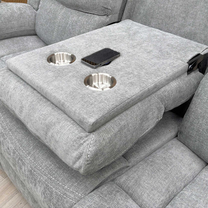 Close-up shot of the two circular cup holders within the dropped-down console of the middle seat.