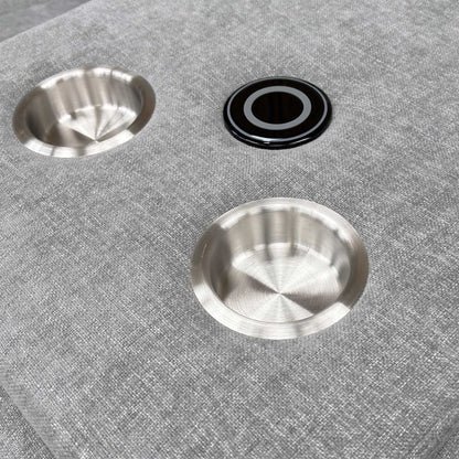 Close-up shot of the two circular cup holders within the dropped-down console of the middle seat.