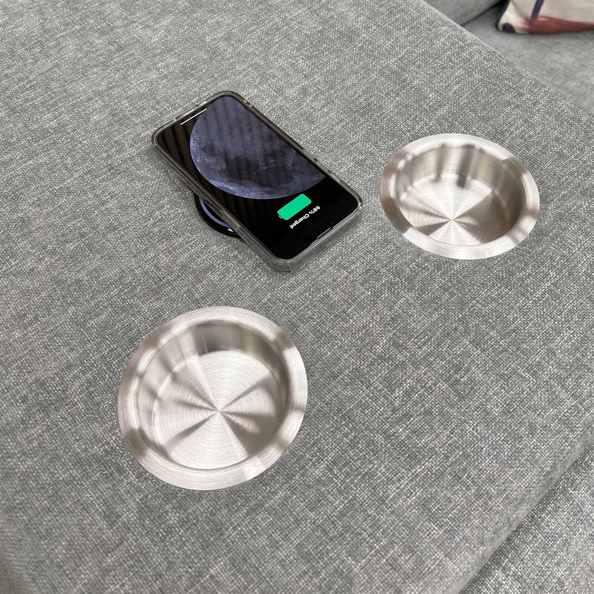 Close-up shot of the two circular cup holders within the dropped-down console of the middle seat.