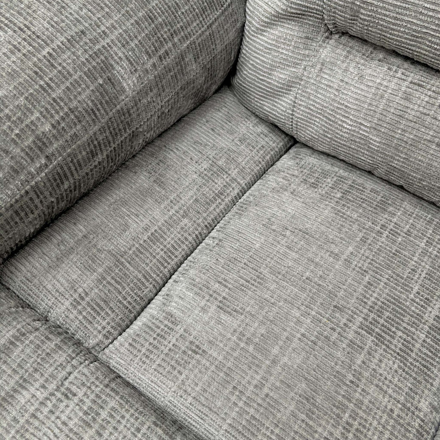 Close-up of the grey fabric texture and stitching.