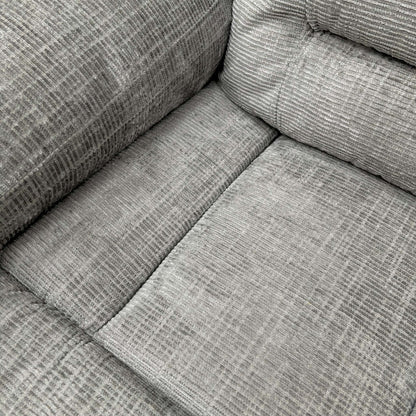 Close-up of the grey fabric texture and stitching.