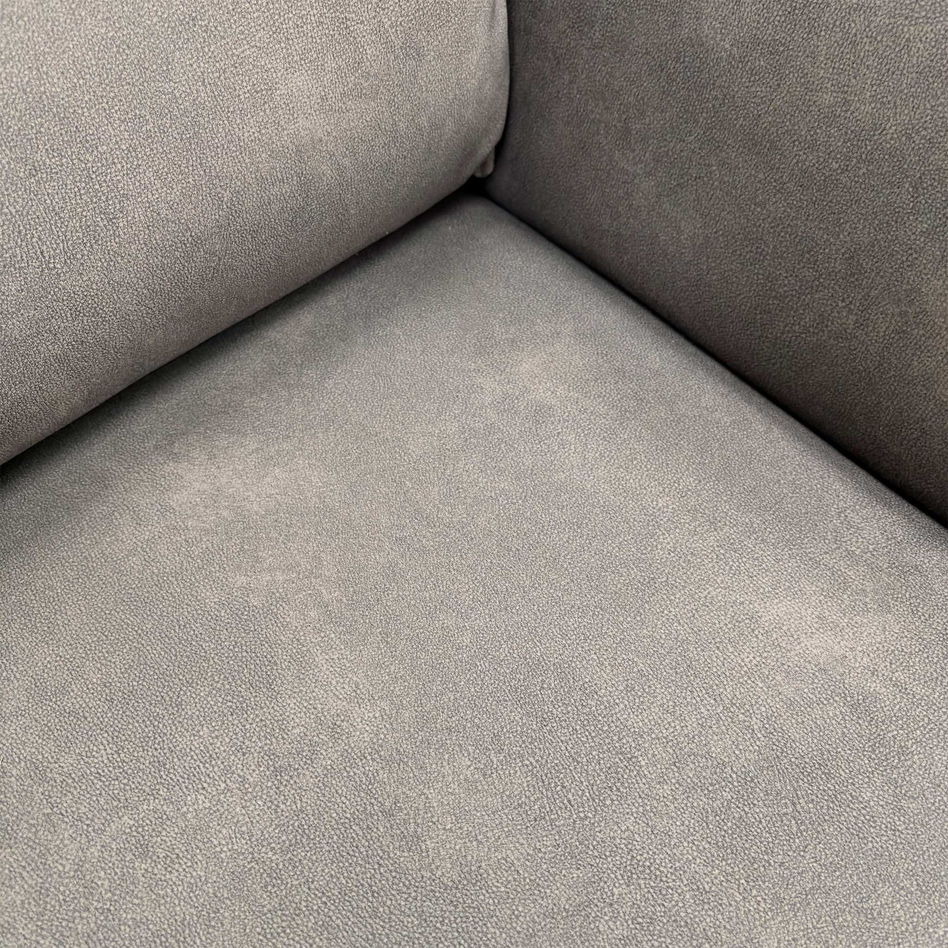 Close-up detail of the Dexter Mocha high-quality fabric upholstery and cushioned armrest.