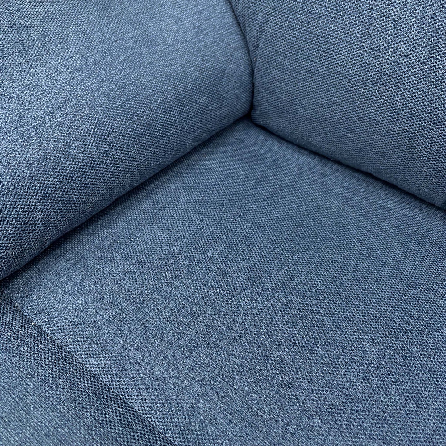 Close-up of the blue fabric and stitching details.