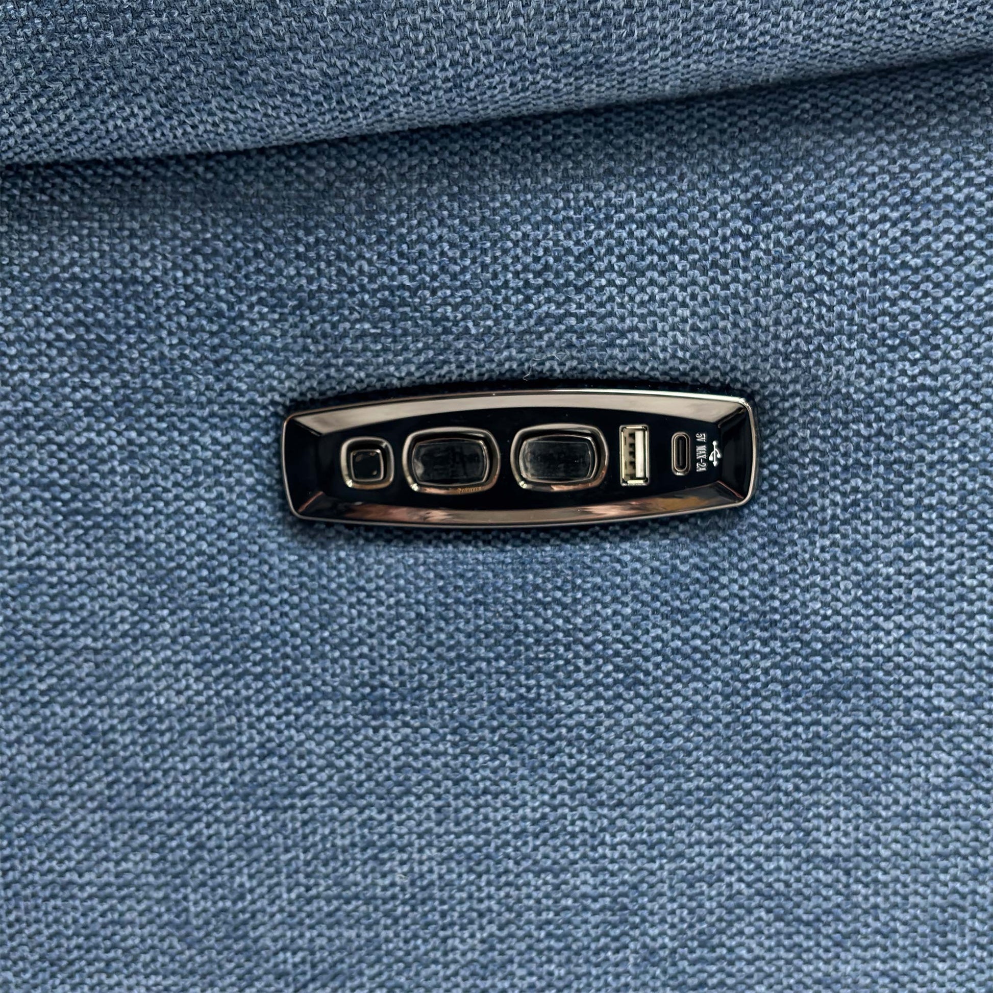 Side view of the sofa, showing the armrest and power controls/USB port.