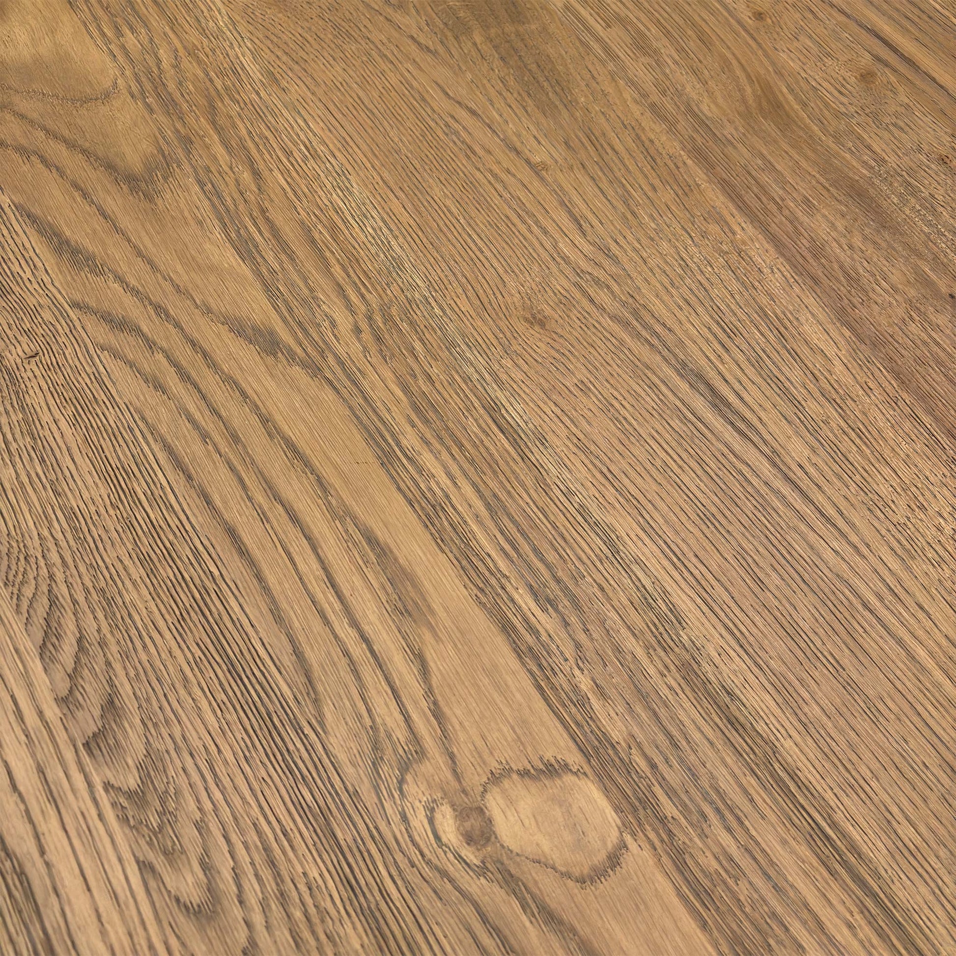 Close-up of the rustic solid oak table top surface, highlighting natural wood grain and knots.