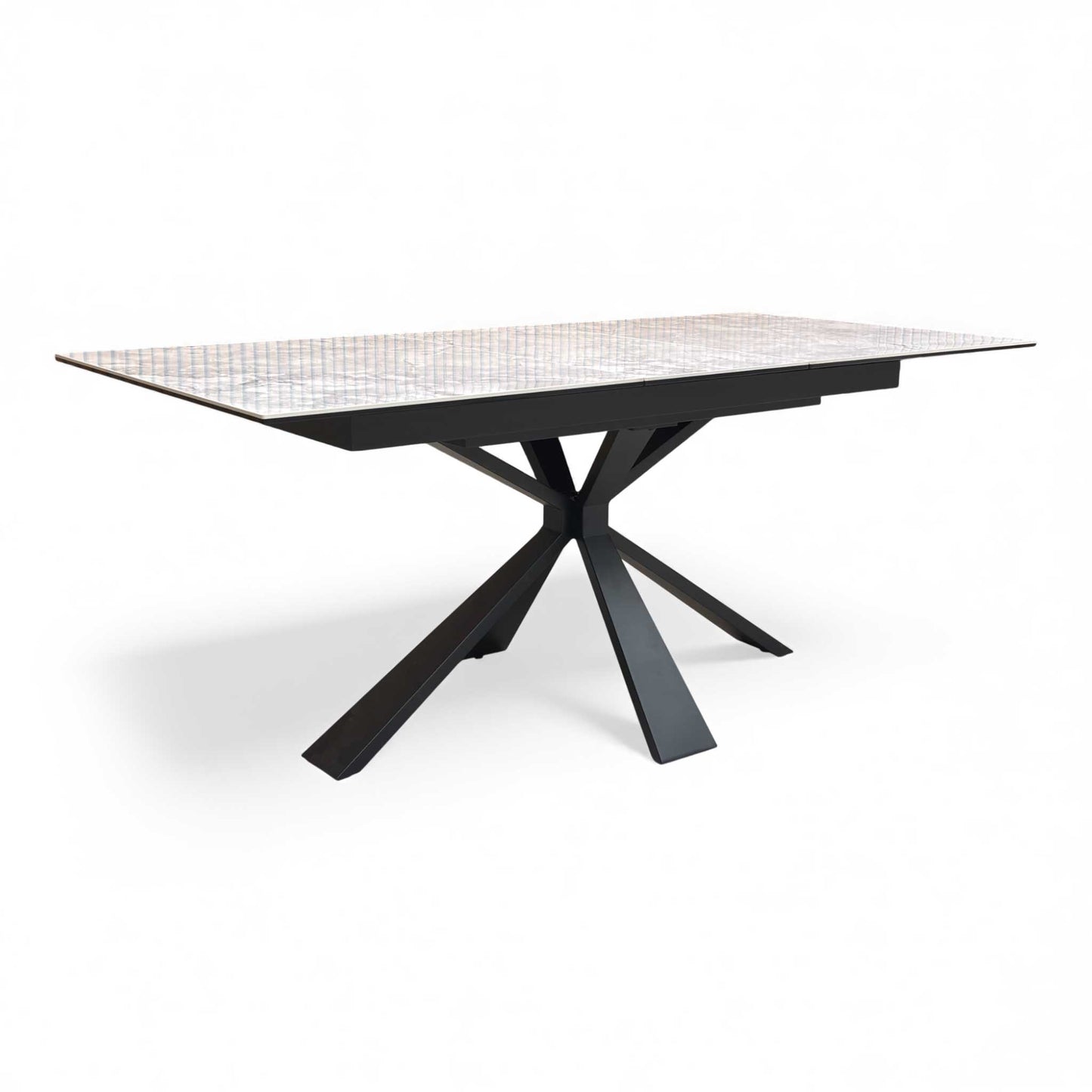 Angled view of the white ceramic extending dining table in its closed state.