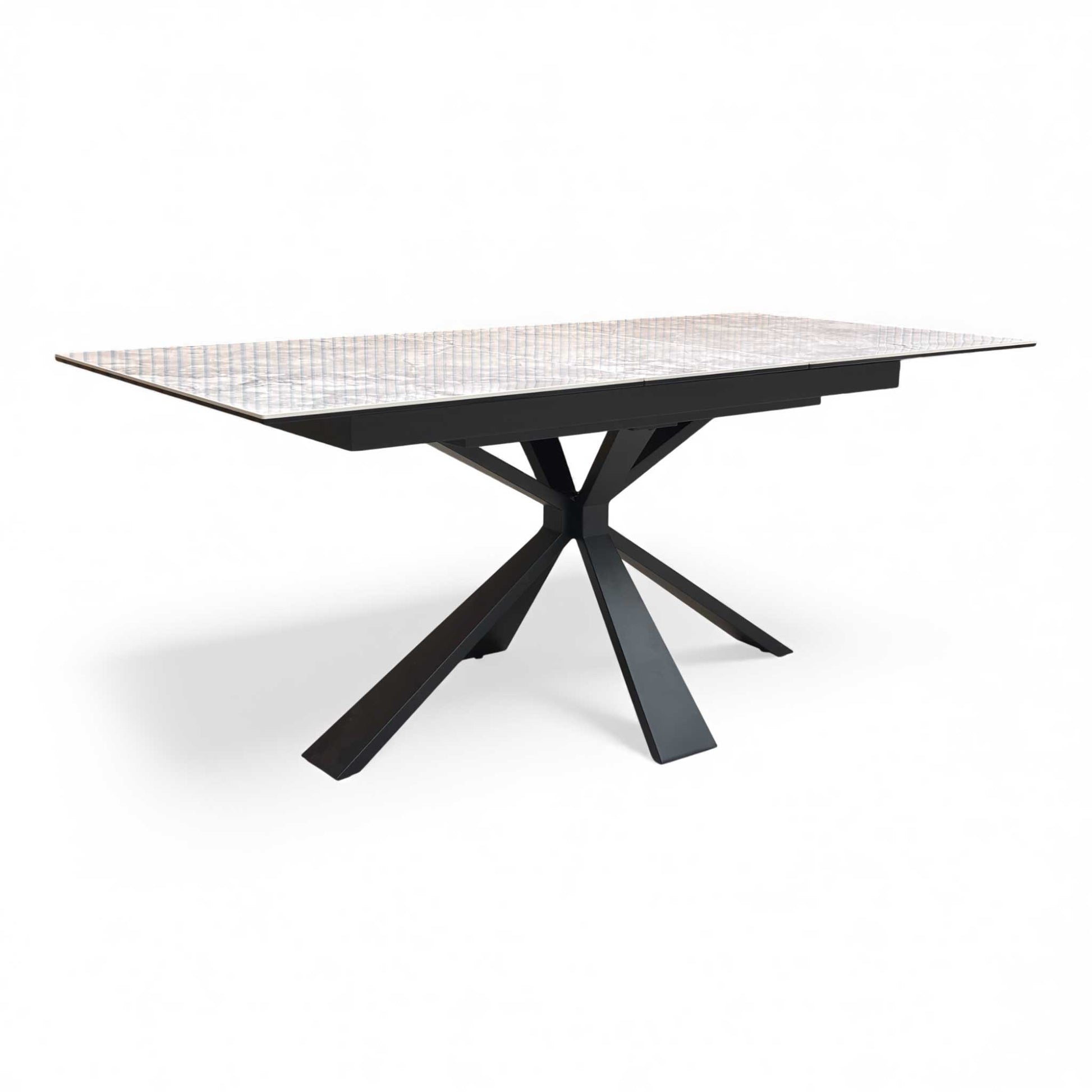 Angled view of the white ceramic extending dining table in its closed state.