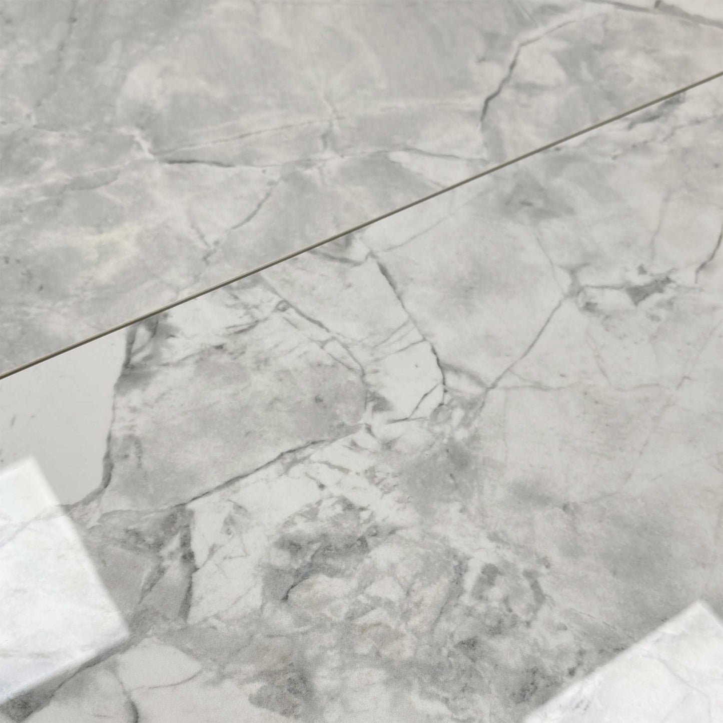 Close-up of the high-gloss white ceramic table top.