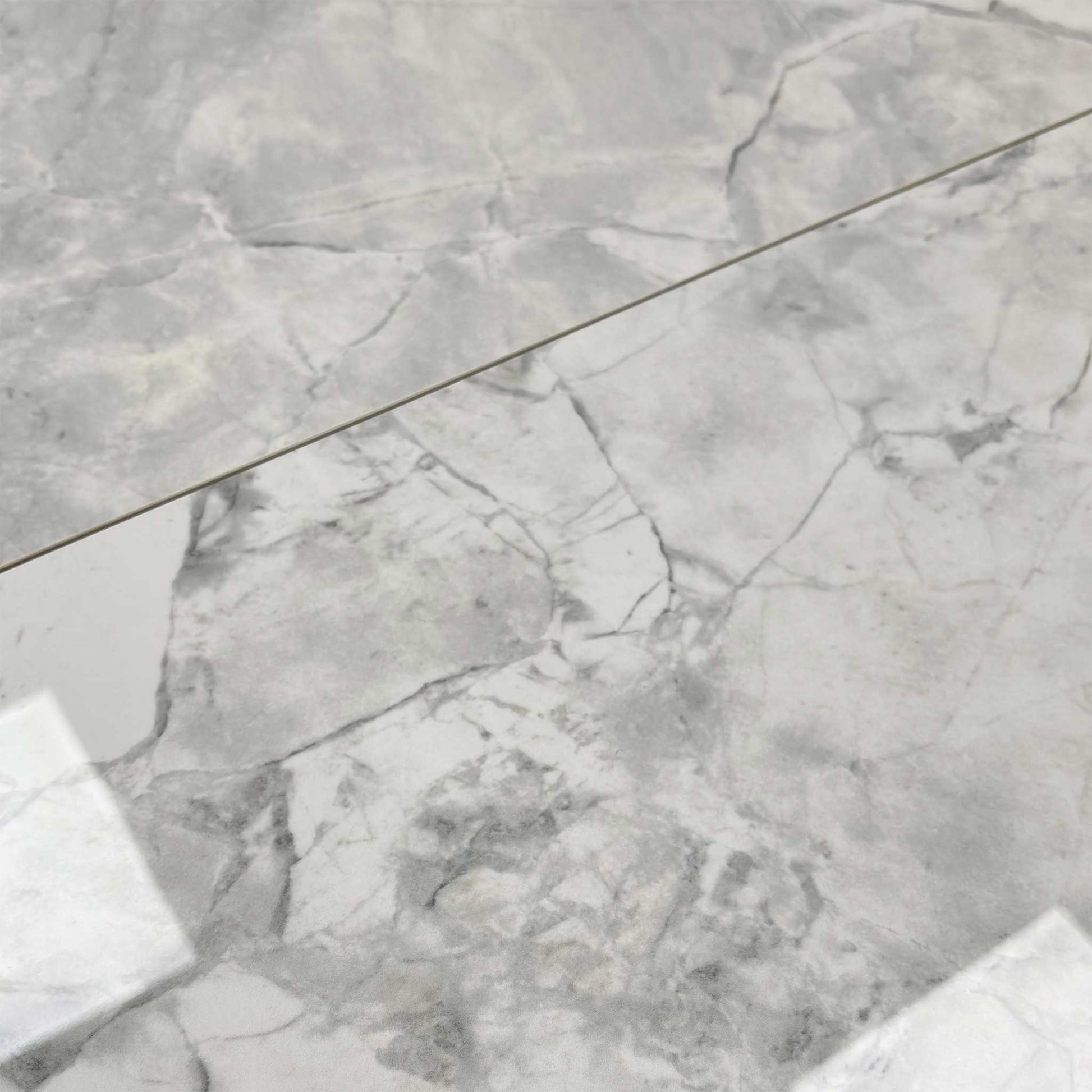 Close-up of the high-gloss white ceramic table top.