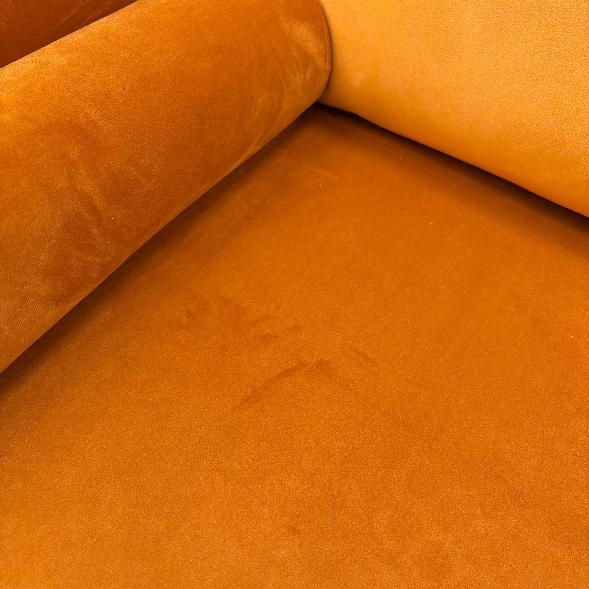 Close-up of the sumptuous Marigold Velvet upholstery texture.
