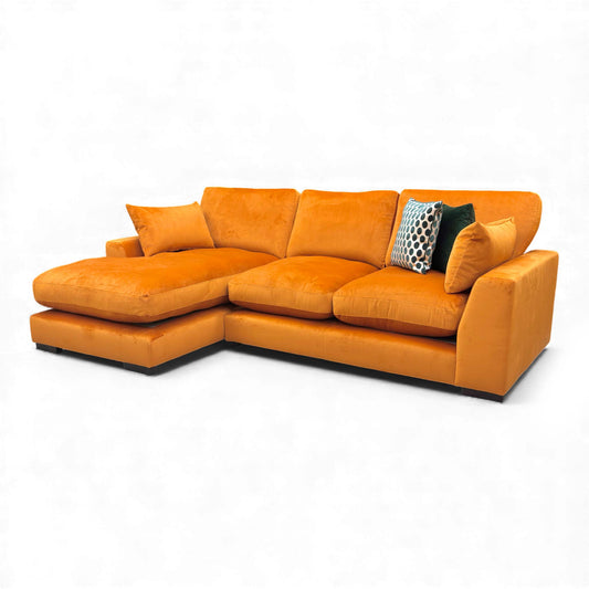 Full front-facing view of the DFS 'Plush' small chaise end sofa in vibrant orange Sensual Velvet.