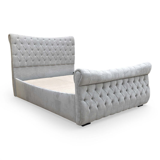 Front-on view of the 'Lance' King bed frame in Dapple Oyster velvet, showcasing the high scrolled headboard with deep buttoning.