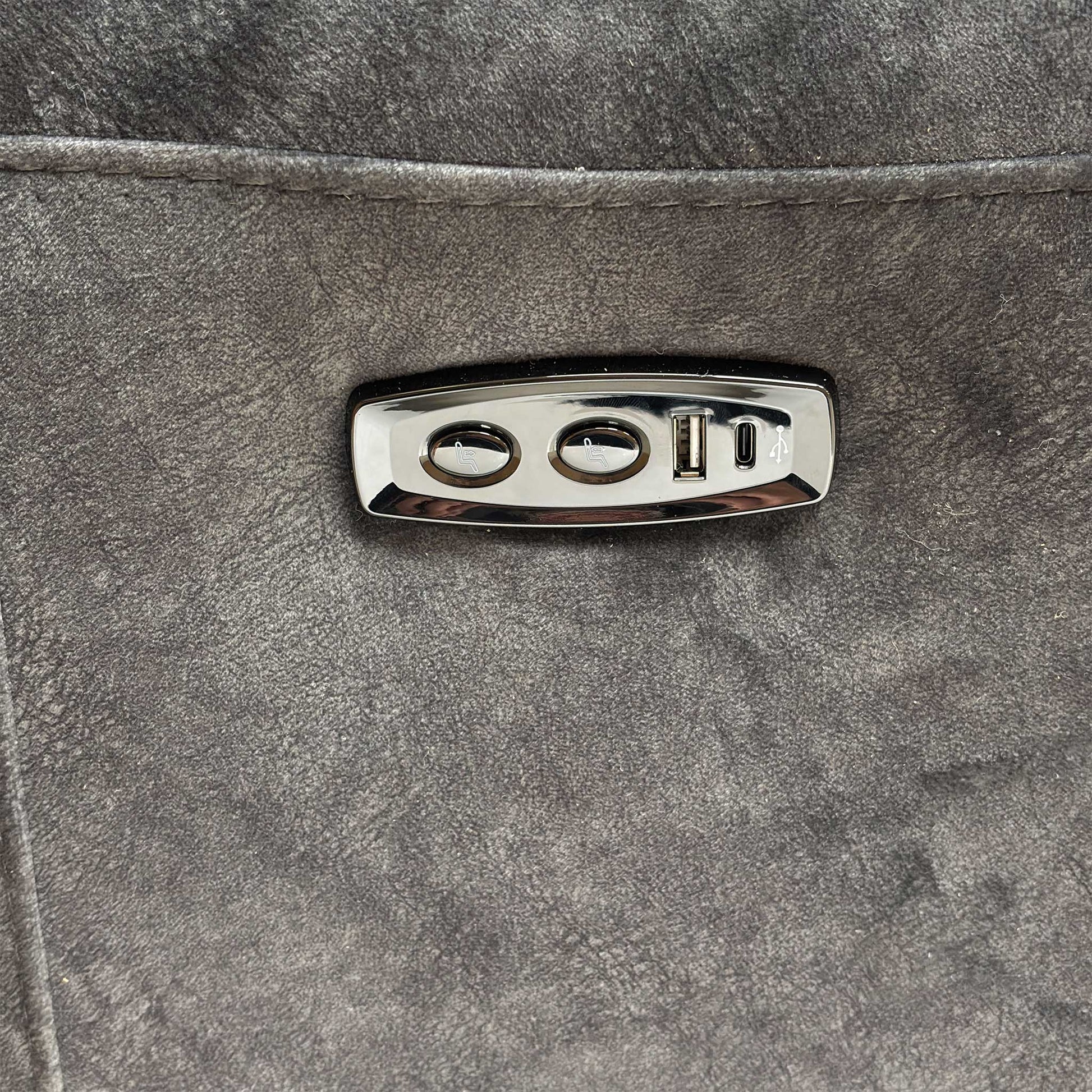 Close-up detail of the integrated power controls and USB charging port on the side of the sofa.