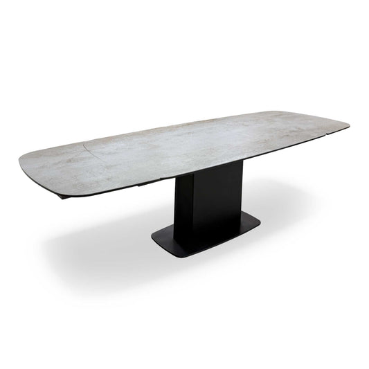 Frontal view of the 'Catalina' Grey Ceramic Extending Dining Table (unextended) with its asymmetric pedestal base.
