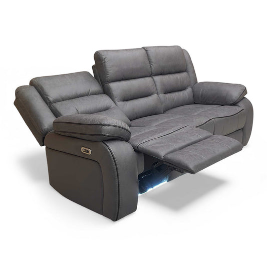 Angle View of Thornbrook 'Vegas' Charcoal Grey Microfibre 3-Seater Power Recliner Sofa in a modern living room setting.