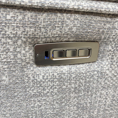 Detail of the power control buttons and USB charging port on the armrest.