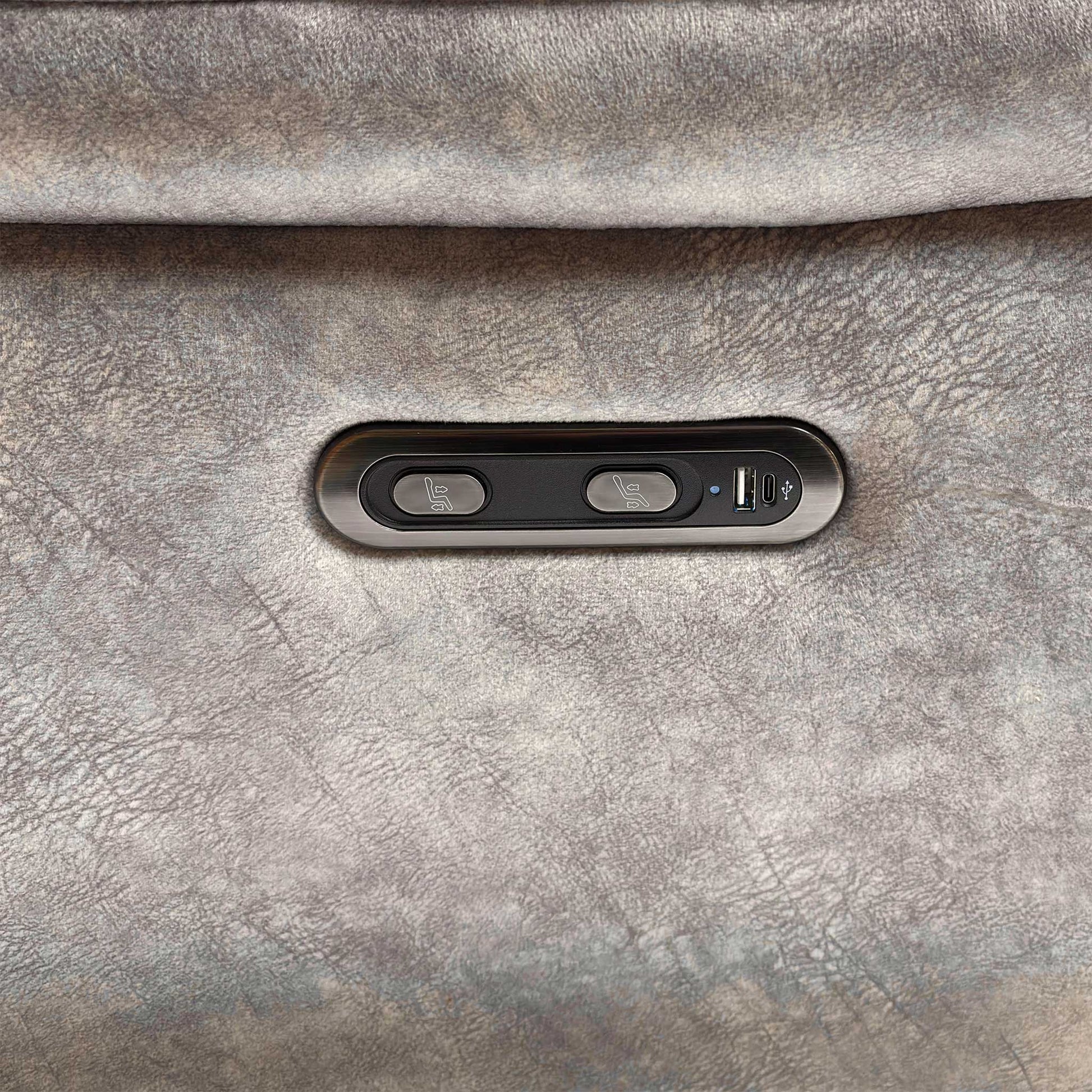 Close-up view of the armrest and side panel of the 'Sloane' Power Recliner Sofa, detailing the soft Marble Stone Grey Velvet upholstery and the embedded control buttons for the power recline function.
