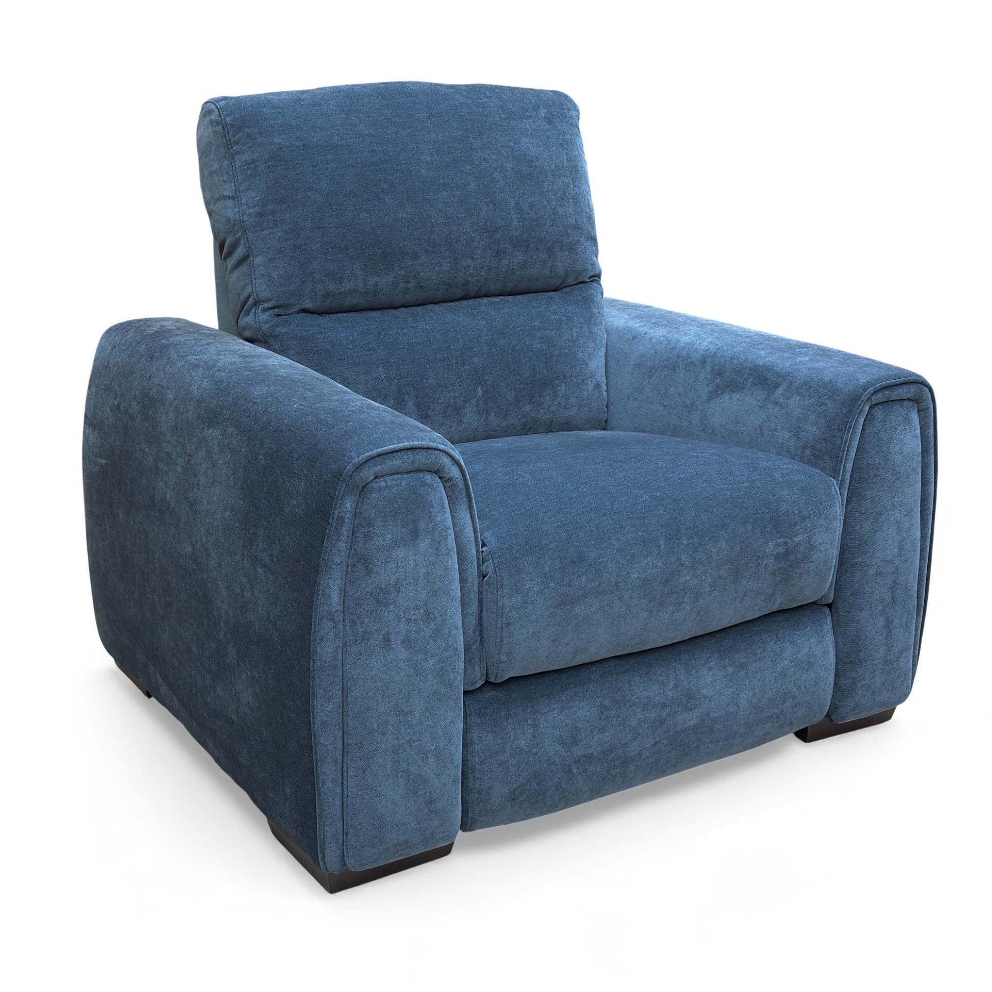 An angled view of the Steel Blue Velvet Armchair, showing the texture of the fabric.