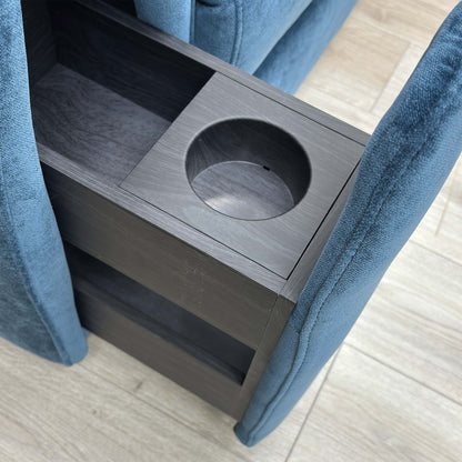 Close-up of the armchair's storage arm pulled out, showing the integrated cup holder.