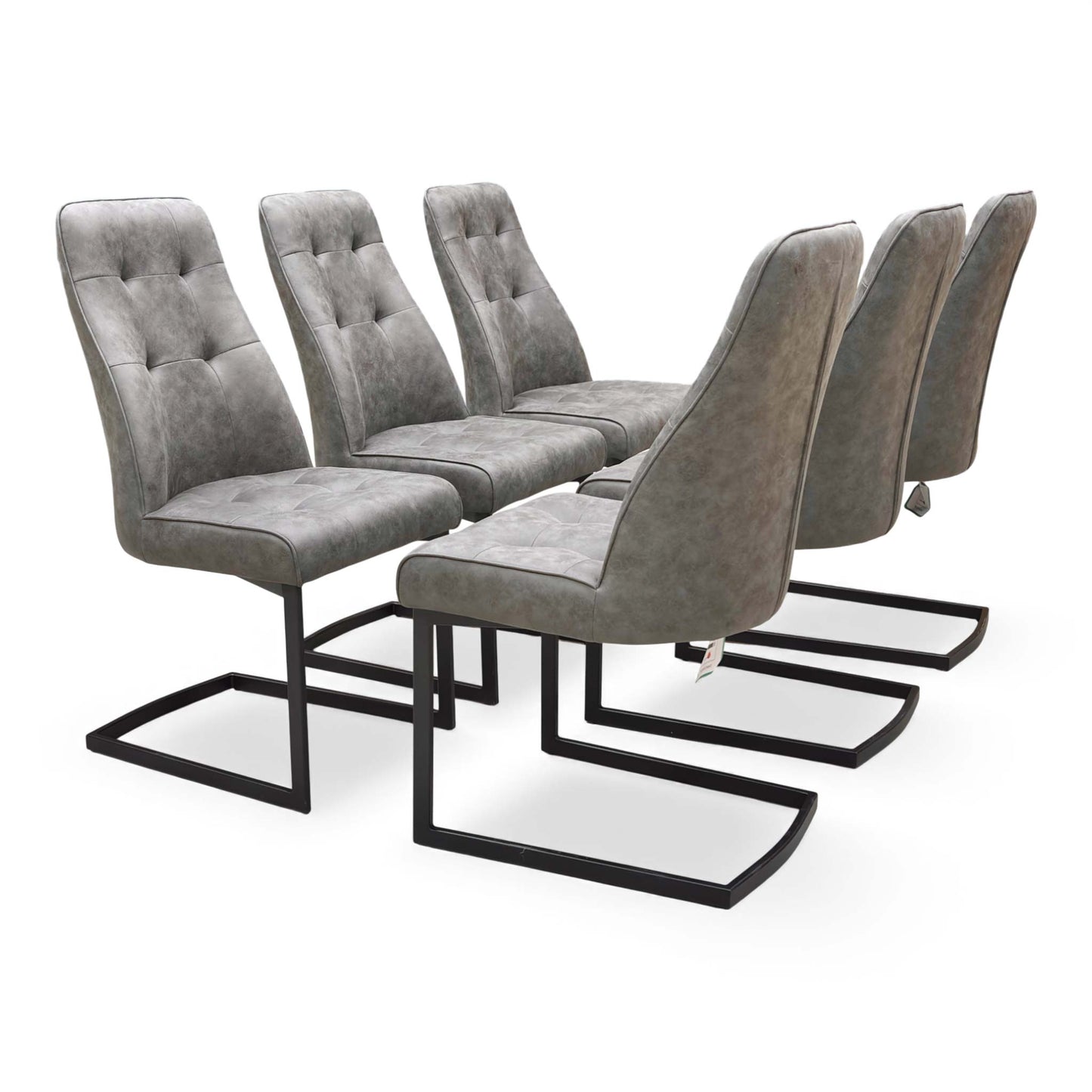 Full view of the set of six ‘Merlin’ Cantilever Dining Chairs in Charcoal Grey Fabric (H 98 cm, W 51 cm) in a dining room setting.