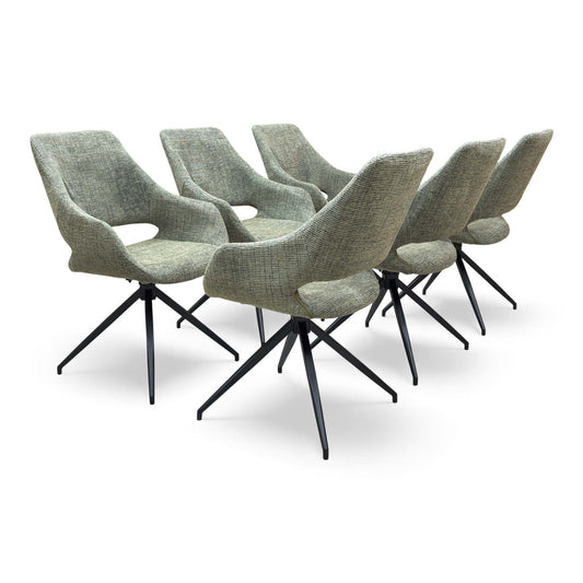 The ‘Charlotte’ Swivel Dining Chair in Sage Green Tweed, showcasing the bucket seat design and black star base.