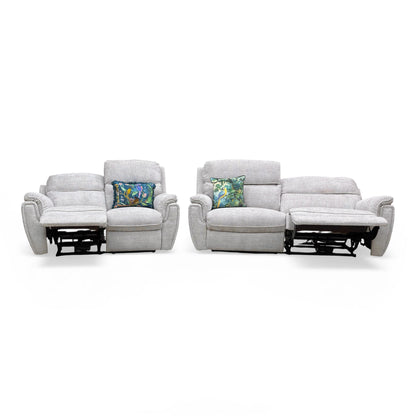 Full frontal view of the entire set with one seat reclined on each sofa.