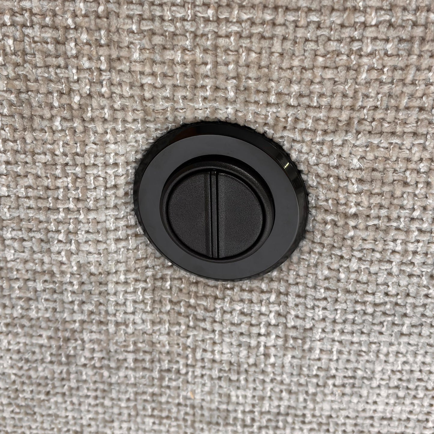 Detail of the electric recliner control buttons located on the side of the armrest.