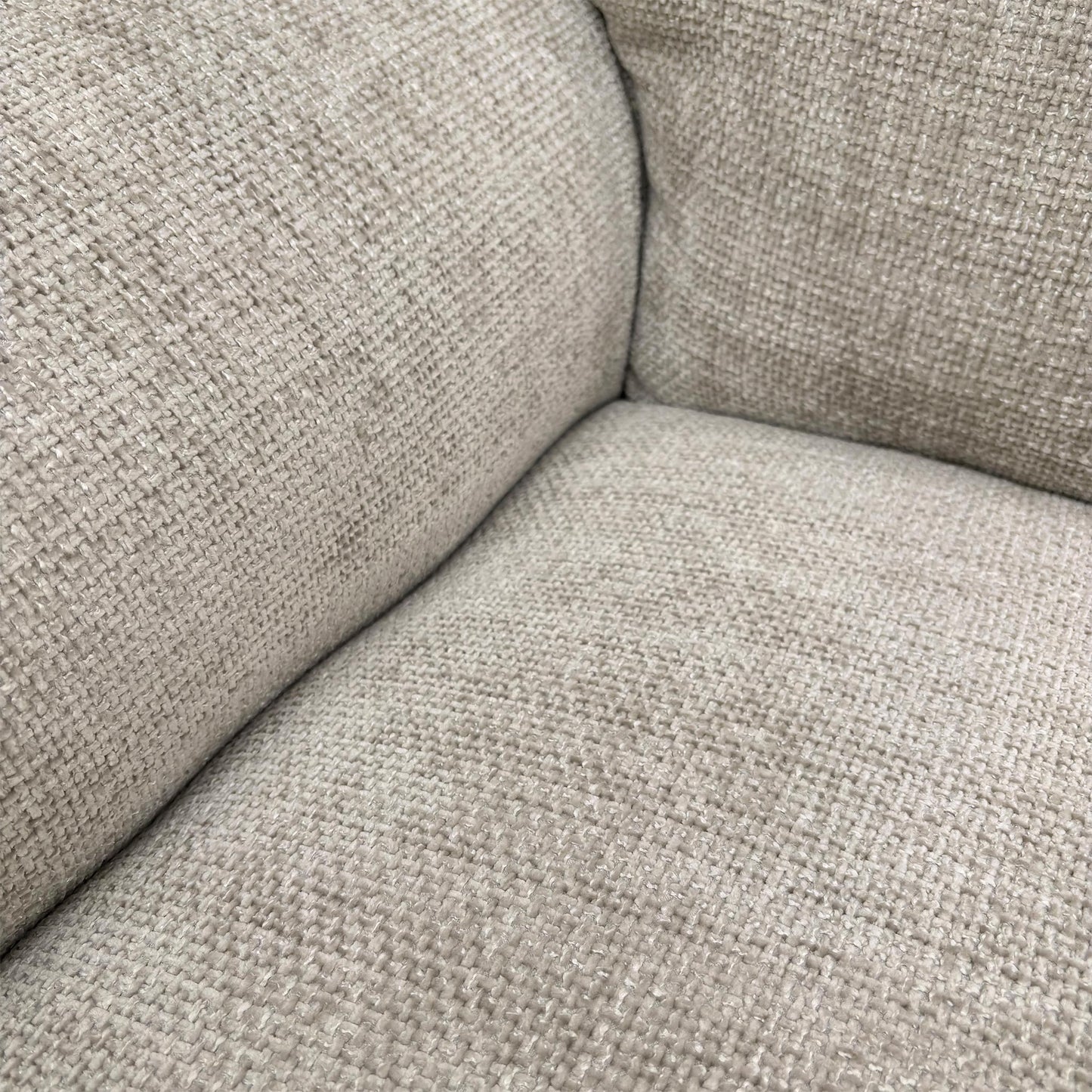 Close-up of the Chunki Pumice Woven Fabric upholstery and stitching detail.