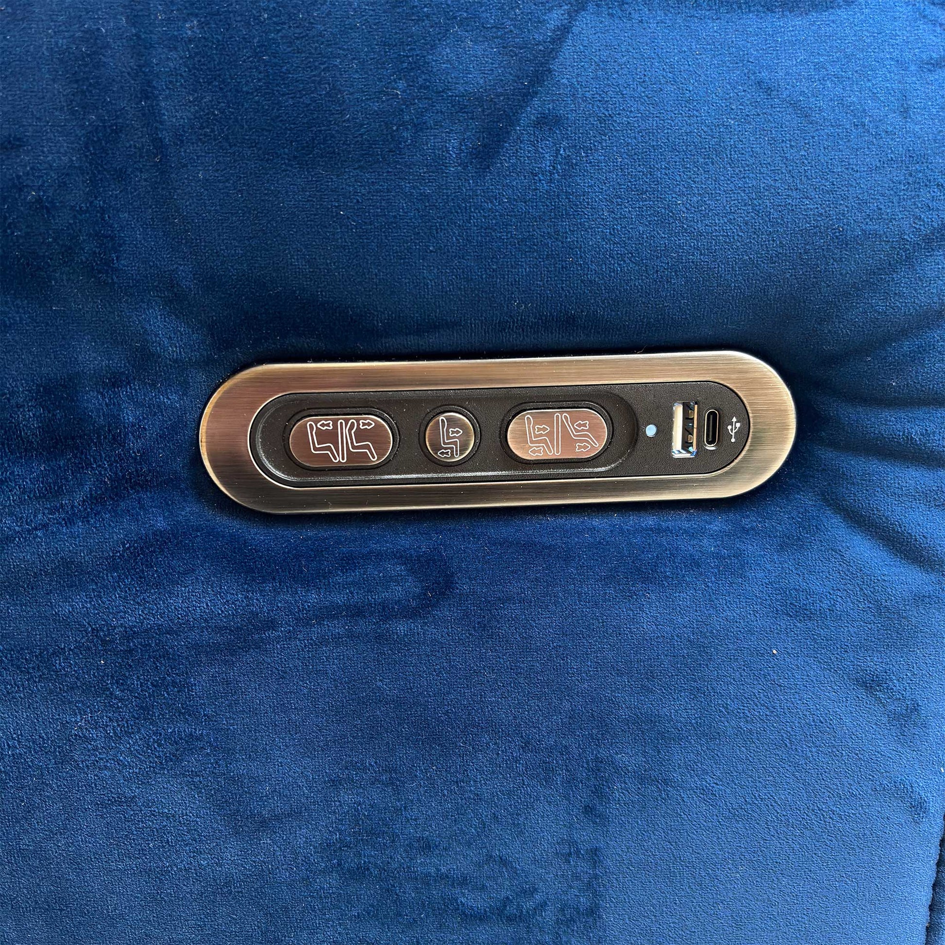 Detail of the discreet power control buttons and built-in USB charging port on the Ezra sofa.
