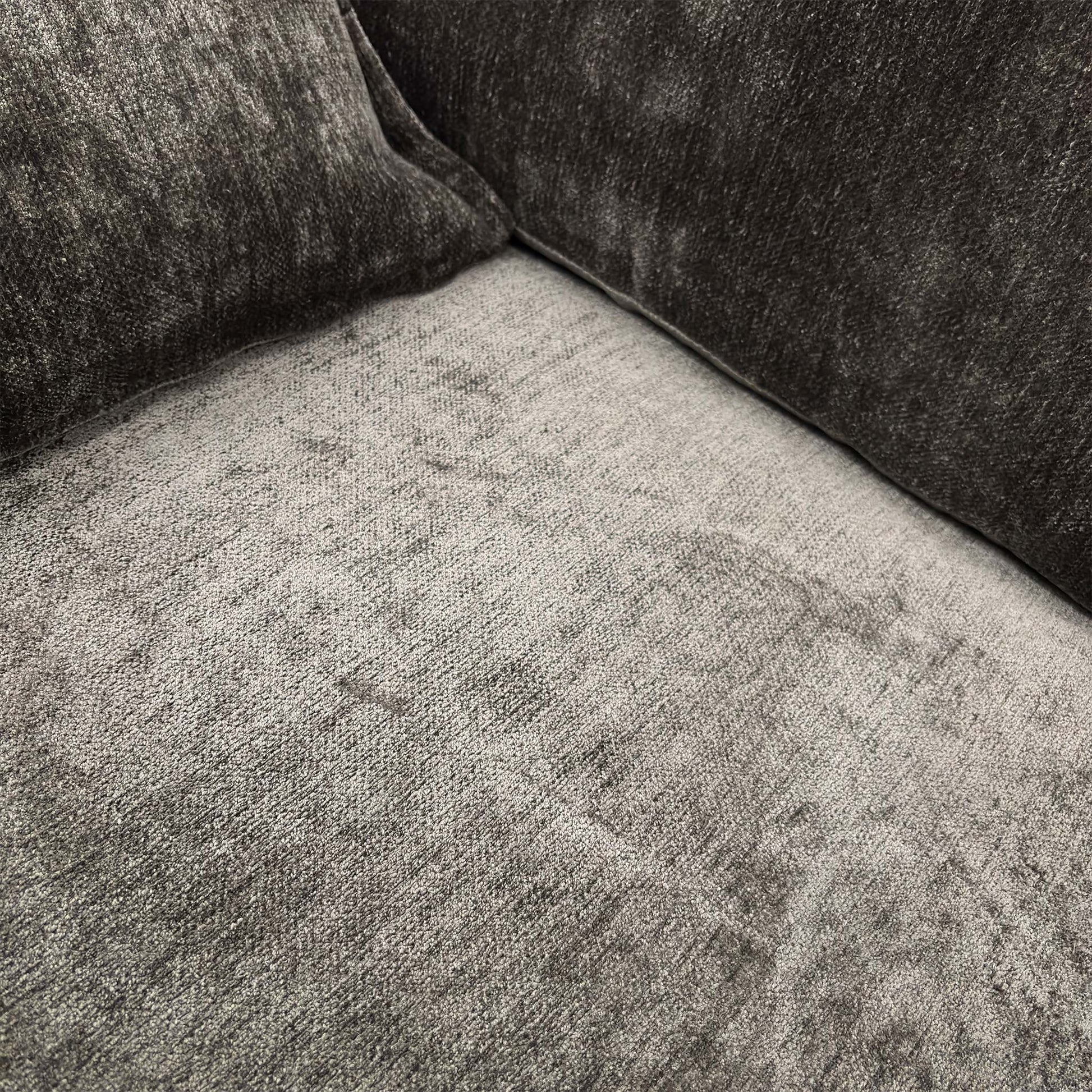 Close-up of the brown chenille fabric and seat cushion detail.