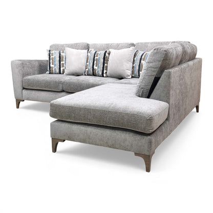 View of the sofa showing the high armrest and formal back cushions.